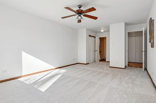 unfurnished bedroom featuring baseboards, light carpet, and ceiling fan