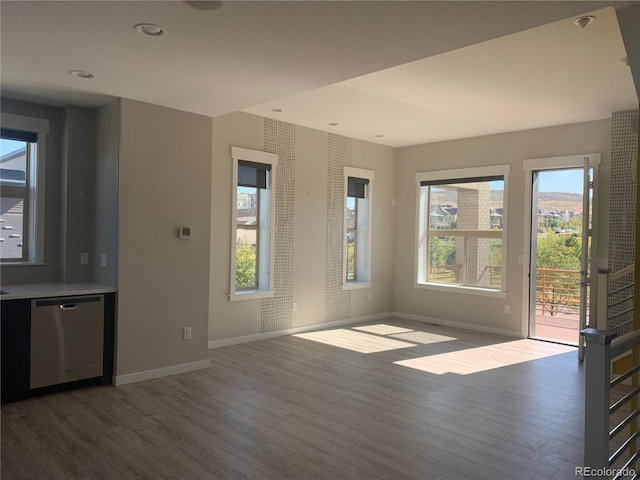 interior space featuring recessed lighting, baseboards, and wood finished floors