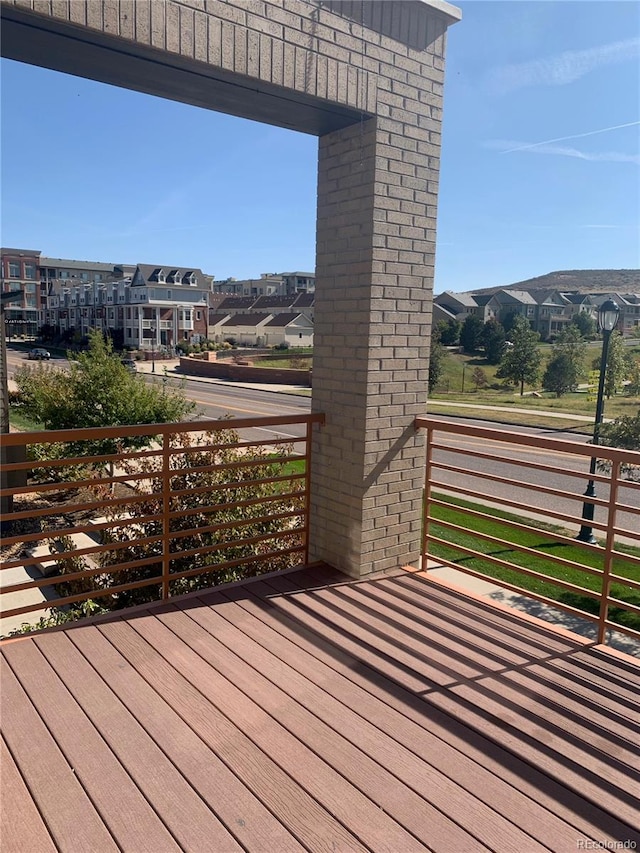 wooden deck with a residential view