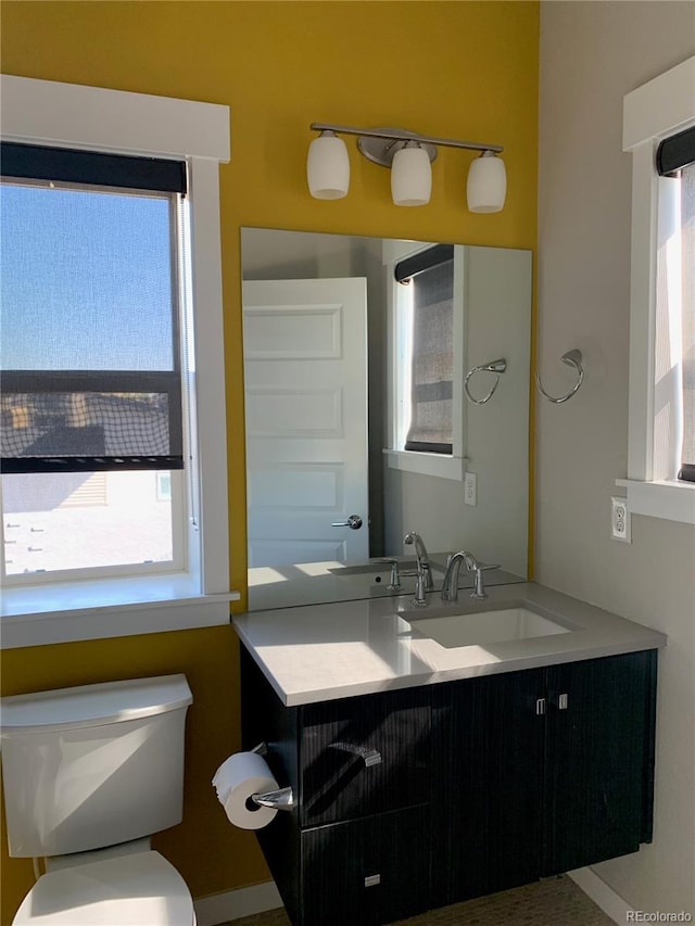 bathroom featuring vanity and toilet