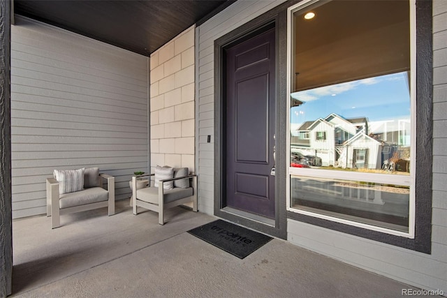 view of exterior entry featuring covered porch