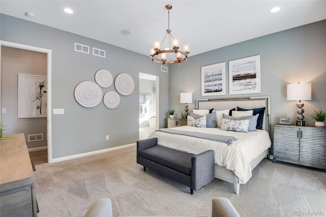 carpeted bedroom with ensuite bath and a chandelier