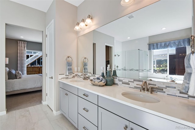 bathroom featuring tile patterned flooring, vanity, and decorative backsplash