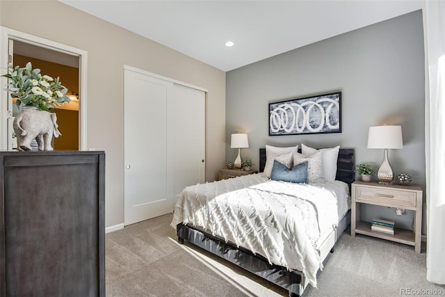 bedroom with light colored carpet and a closet