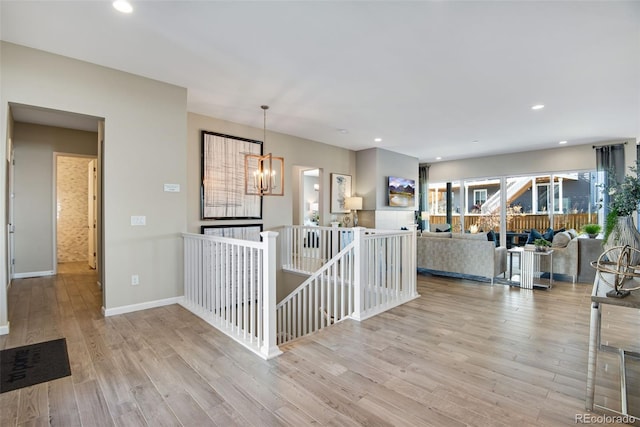 interior space featuring light hardwood / wood-style floors and an inviting chandelier