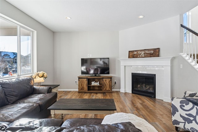 living room with a healthy amount of sunlight, hardwood / wood-style floors, and a fireplace