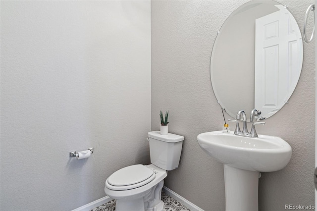 bathroom featuring sink and toilet