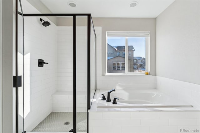 bathroom with shower with separate bathtub