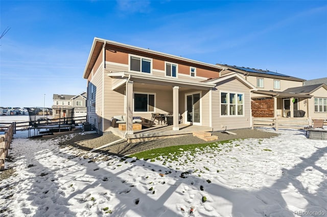 snow covered property featuring a patio