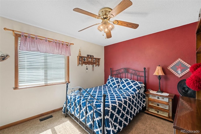 bedroom with ceiling fan, baseboards, visible vents, and carpet flooring