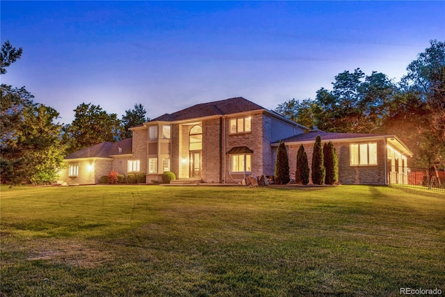view of front of property featuring brick siding and a front yard