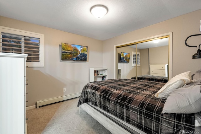 carpeted bedroom with baseboards, baseboard heating, and a closet