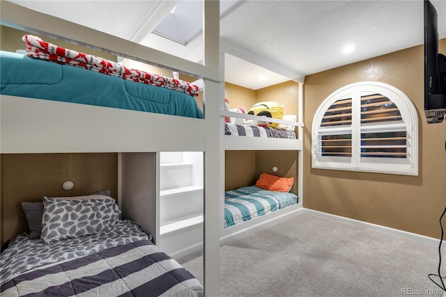carpeted bedroom featuring baseboards