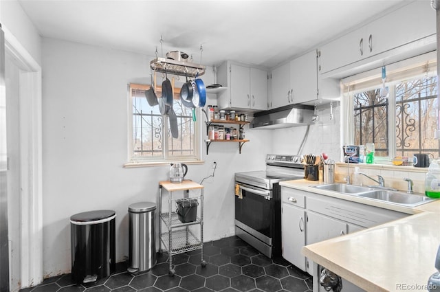 kitchen with under cabinet range hood, stainless steel electric range, a wealth of natural light, and a sink