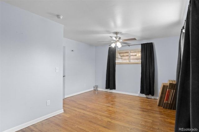 empty room with light wood-type flooring, baseboards, and ceiling fan