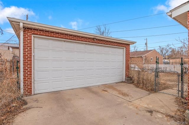 detached garage with a gate and fence