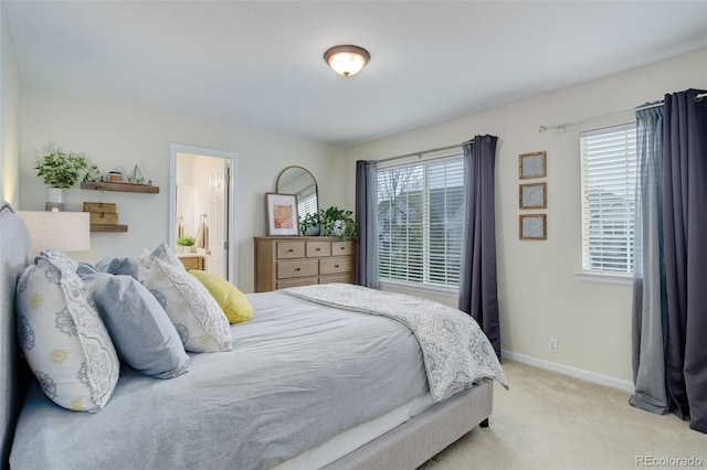 bedroom featuring carpet floors, baseboards, and ensuite bathroom