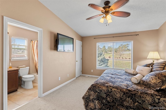 20466 Willowbend Ln, Parker, CO 80138 - bedroom featuring baseboards, connected bathroom, a textured ceiling, and lofted ceiling