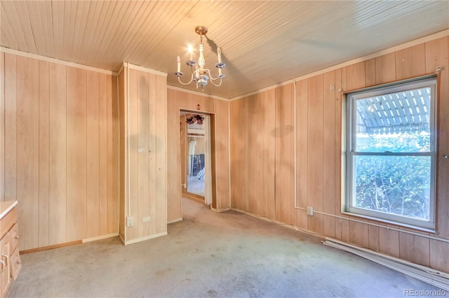 carpeted empty room featuring wooden walls, a chandelier, and wooden ceiling