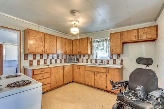 kitchen featuring sink and electric range