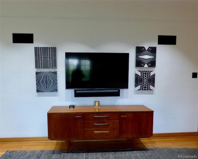room details featuring baseboards and wood finished floors