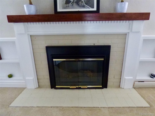 interior details with a glass covered fireplace and built in features
