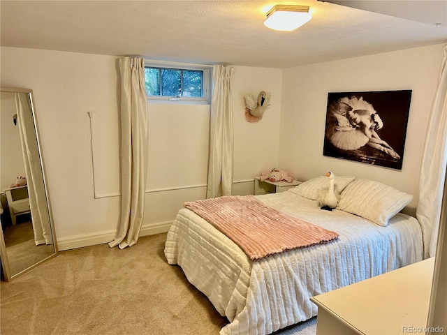 carpeted bedroom featuring baseboards