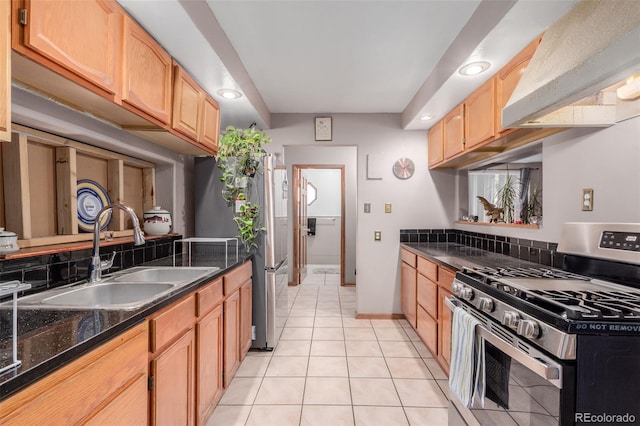 kitchen featuring appliances with stainless steel finishes, light tile patterned flooring, light brown cabinets, ventilation hood, and sink