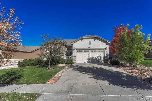 ranch-style home featuring a front lawn and a garage