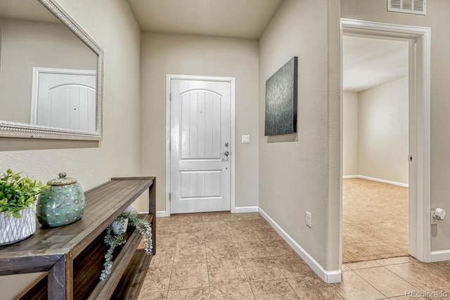 doorway featuring light carpet