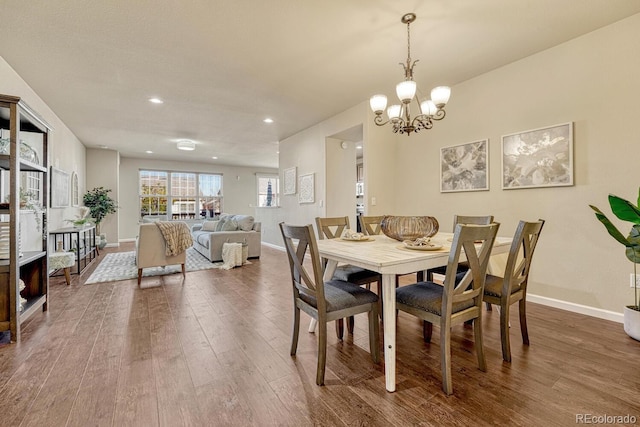 dining room featuring hardwood / wood-style floors and a notable chandelier