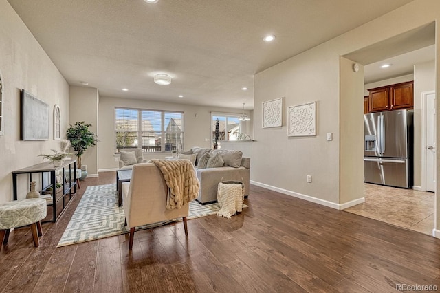 living room with wood-type flooring and a textured ceiling