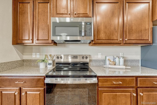 kitchen featuring light stone countertops and stainless steel appliances