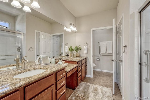 bathroom with tile patterned flooring, toilet, a shower with door, and vanity