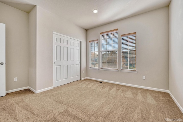 unfurnished bedroom featuring a closet and carpet