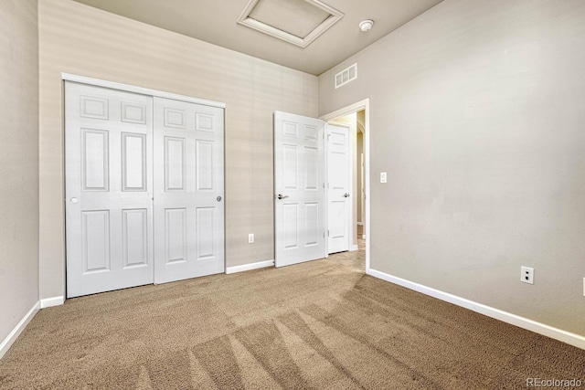 unfurnished bedroom featuring a closet and carpet flooring