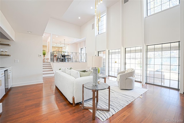 living room featuring a high ceiling and dark hardwood / wood-style floors