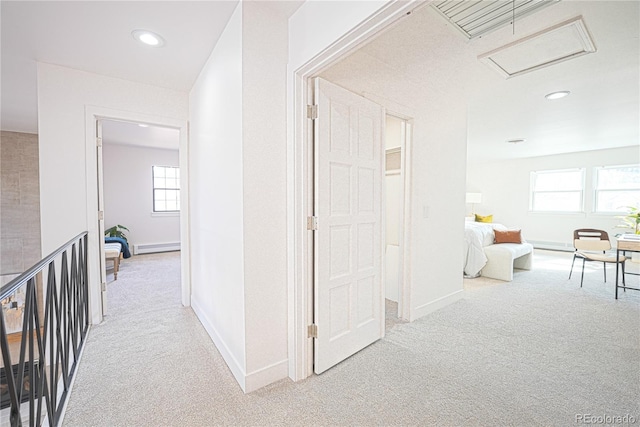 corridor featuring carpet and a baseboard heating unit