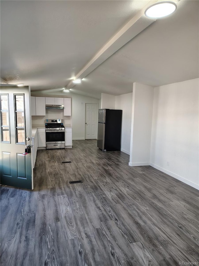 kitchen with vaulted ceiling with beams, stainless steel appliances, baseboards, white cabinets, and dark wood finished floors