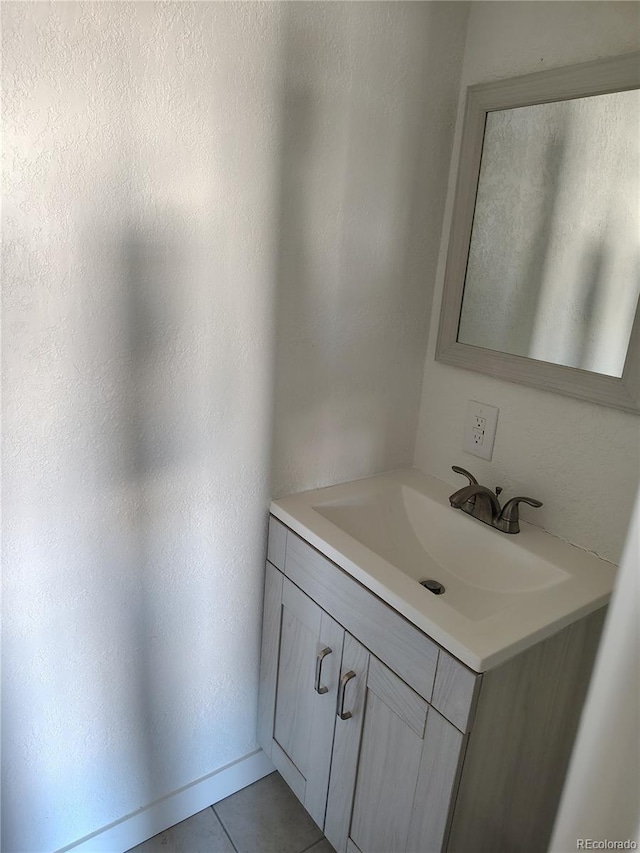 bathroom with tile patterned floors and vanity