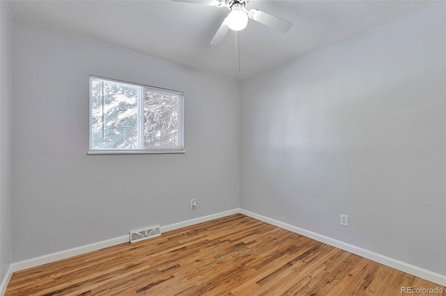 empty room featuring hardwood / wood-style floors and ceiling fan