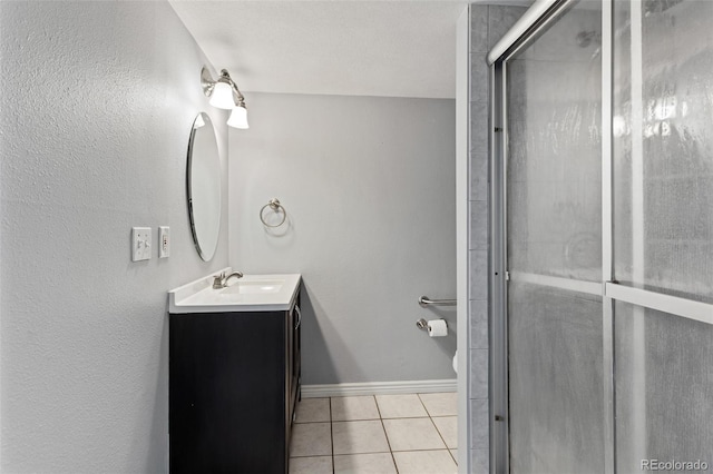 6711 S Race St, Centennial, CO 80122 - bathroom featuring tile patterned floors, vanity, a stall shower, and baseboards