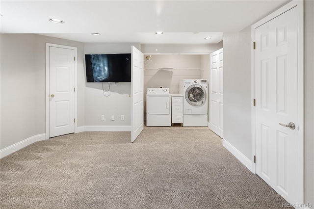 clothes washing area featuring recessed lighting, baseboards, washer and clothes dryer, light carpet, and laundry area