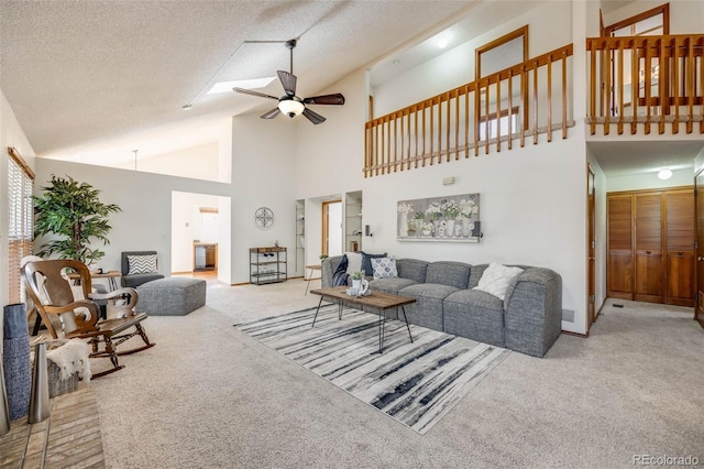 10436 W 84th Pl, Arvada, CO 80005 - carpeted living area featuring baseboards, a textured ceiling, high vaulted ceiling, and ceiling fan
