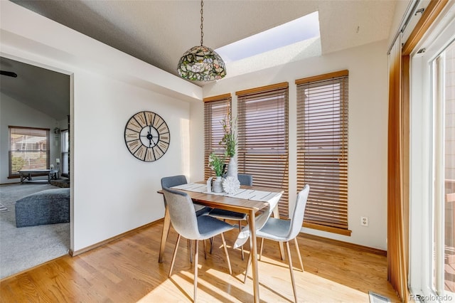 10436 W 84th Pl, Arvada, CO 80005 - dining room featuring vaulted ceiling, light wood finished floors, and baseboards