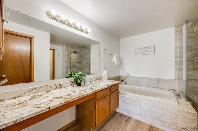 10436 W 84th Pl, Arvada, CO 80005 - bathroom with a shower stall, a bath, vanity, and wood finished floors