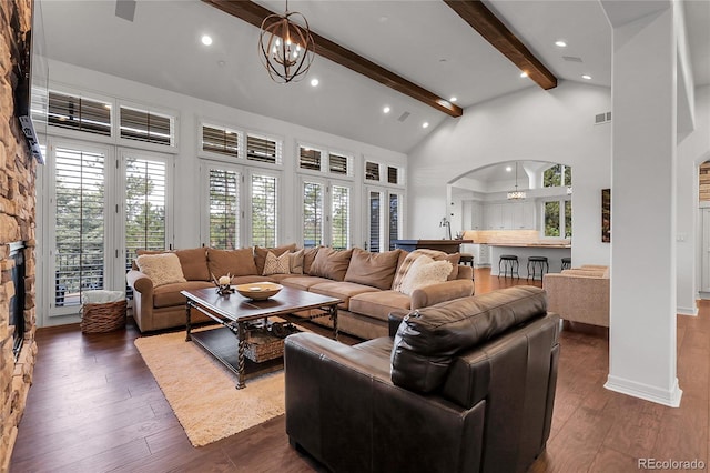 917 Dakota Dr, Castle Rock, CO 80108 - living room featuring arched walkways, beamed ceiling, high vaulted ceiling, dark wood finished floors, and a chandelier