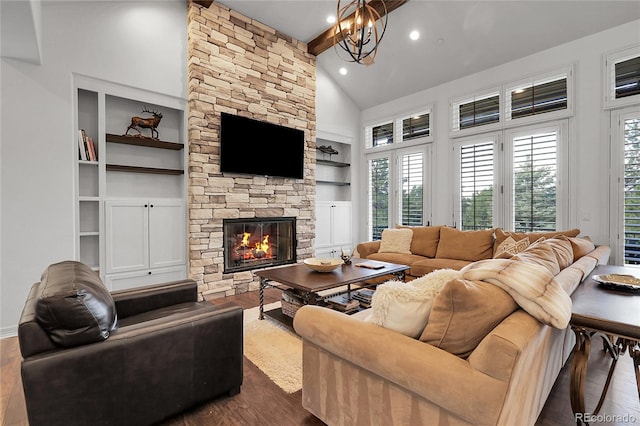 917 Dakota Dr, Castle Rock, CO 80108 - living room featuring dark wood-type flooring, built in shelves, a fireplace, a chandelier, and high vaulted ceiling