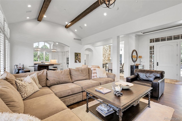 917 Dakota Dr, Castle Rock, CO 80108 - living room featuring arched walkways, beamed ceiling, wood finished floors, recessed lighting, and high vaulted ceiling
