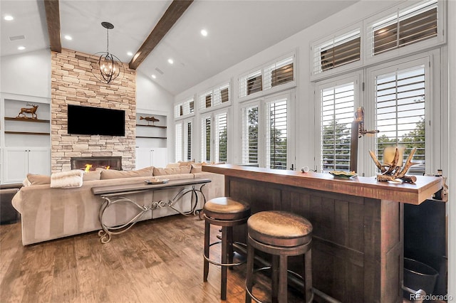 917 Dakota Dr, Castle Rock, CO 80108 - living room with beam ceiling, dark wood-style flooring, high vaulted ceiling, built in features, and a fireplace